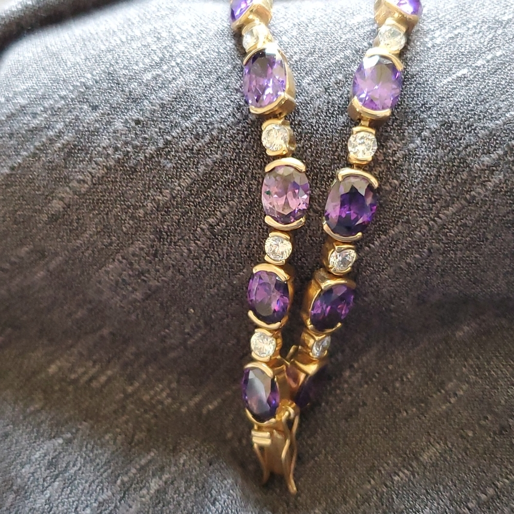Faux amethyst and diamond style goldtone bracelet.